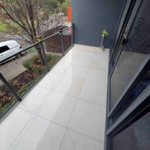 Professional-bathroom-tiler-installing-outdoor-floor-tiles-on-Melbourne-balcony