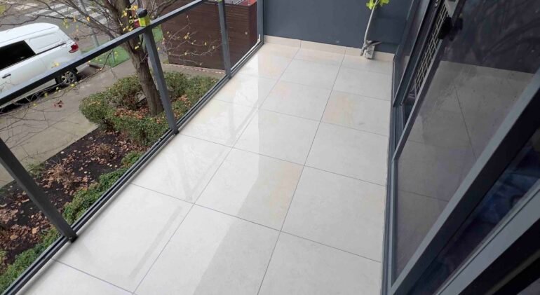 Professional-bathroom-tiler-installing-outdoor-floor-tiles-on-Melbourne-balcony