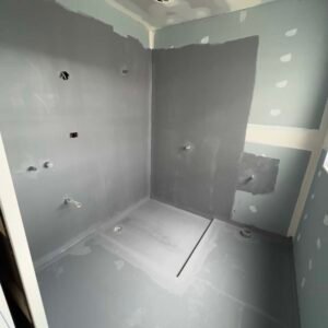 applying waterproofing primer with brush bathroom shower melbourne construction