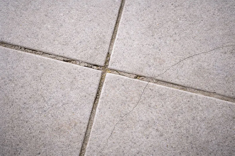 Minor balcony leak repair cost Melbourne showing cracked grout requiring $2000-5000 repair