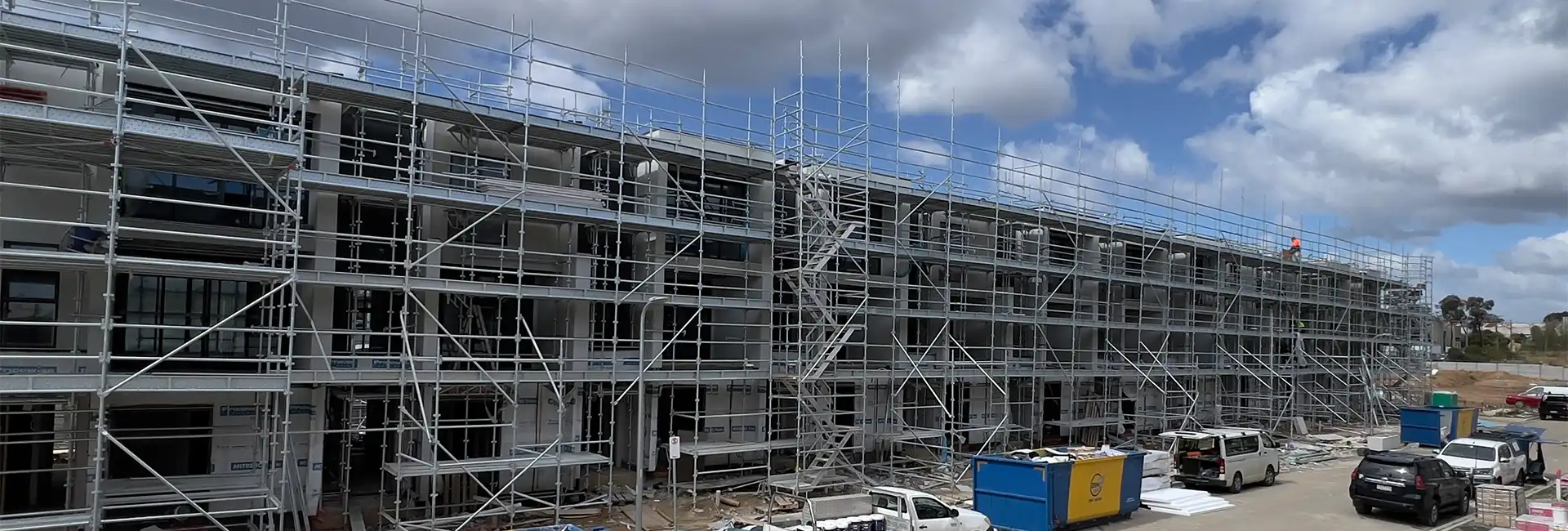 Large townhouse development under construction with scaffolding for rendering work in Melbourne