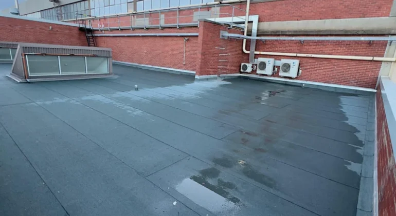 Completed torch on membrane waterproofing on a flat roof commercial building