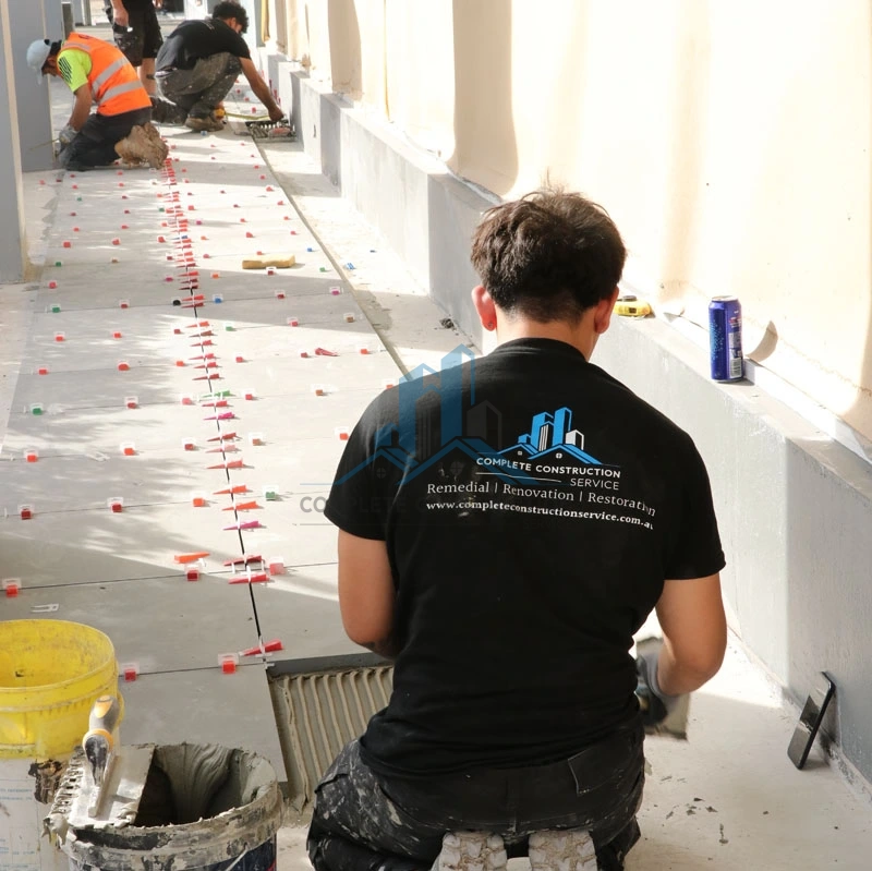 Tradeperson Installing Porch Paver in Glen Eira Counsel Melbourne