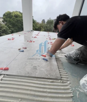 Professional tiler is tiling the balcony in Melbourne