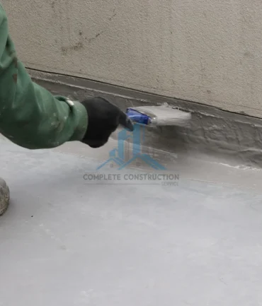 Liquid waterproofing applied to balcony wall junction