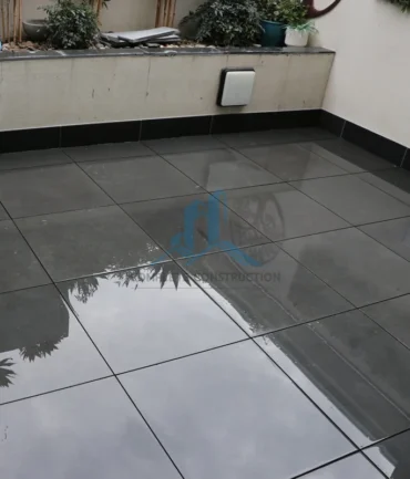 Completed waterproof balcony with dark pedestal pavers