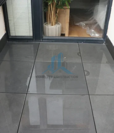 Waterproofed balcony finished with grey pedestal pavers