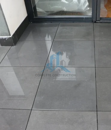 Finished pedestal pavers at balcony entry threshold