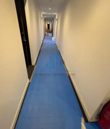 Protected apartment hallway during waterproofing project