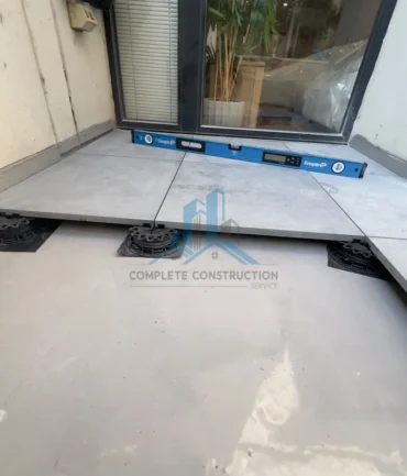 Pedestal pavers levelled during balcony installation