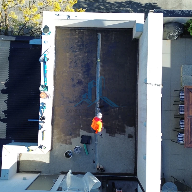 Applying primer coat before screeding across terrace